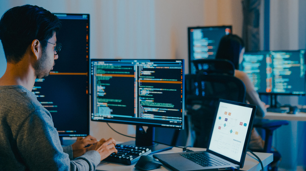 Group Adult Asia male, female freelance typing write prompt AI bot IT app smart program nomad, video game, terminal with coding language, designer, big data center on computer in night office.